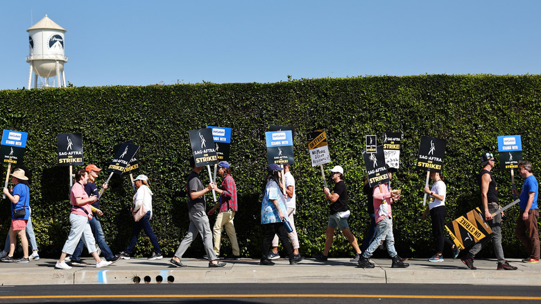 Hollywood writers on strike walking a picket line during the Writers Guild of America labor strike of 2023