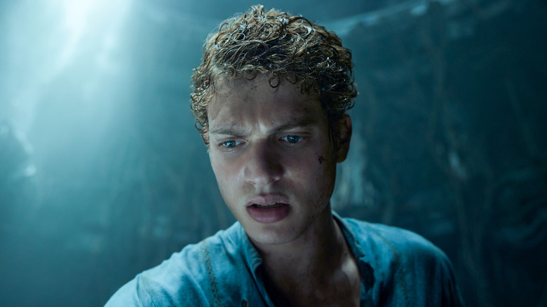 Rand al'Thor frowns at something below in 