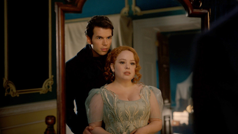 Colin standing behind Penelope in the mirror on Bridgerton