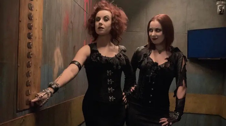 Jen and Sylvia Soska press a button in the Hellevator
