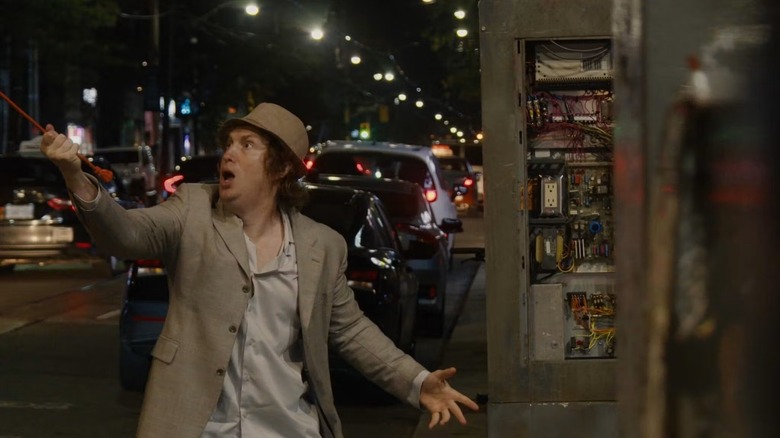 Matt trying to plug in his time travel device in Nirvanna the Band the Show the Movie (2026)