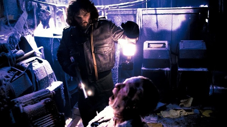 R.J. MacReady investigating a frozen corpse in The Thing (1982)