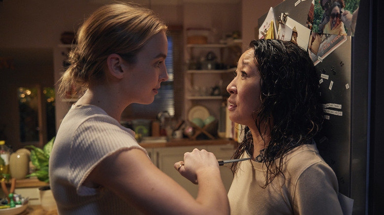 Villanelle holding a knife to Eve's neck in her kitchen on Killing Eve