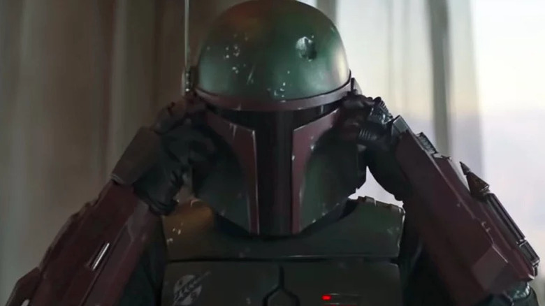 Temuera Morrison's Boba Fett with his hands on his temples in The Book of Boba Fett
