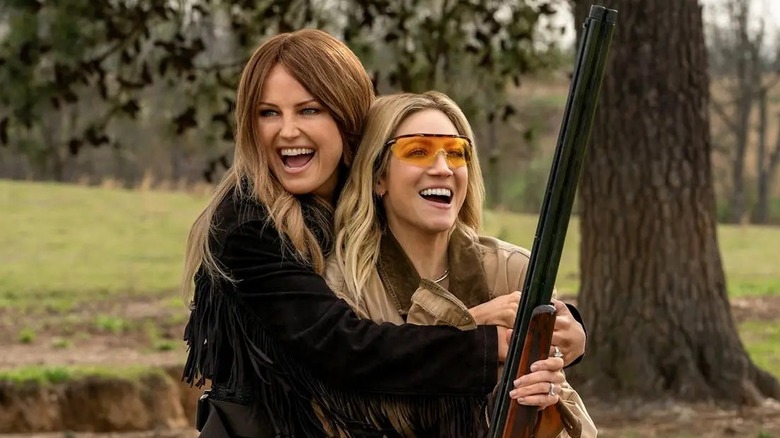 Margo and Sophie hugging with a gun in The Hunting Wives