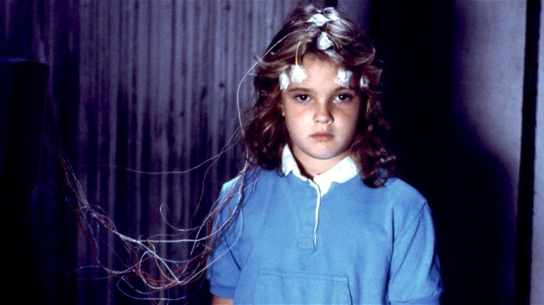 Charlie McGee standing with wires hooked up to head in Firestarter (1984)