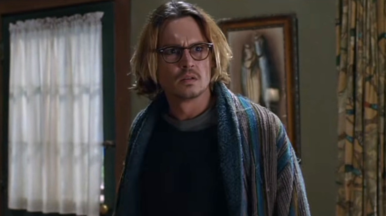 Mort Rainey in a patterned cardigan and glasses looking confused in Secret Window