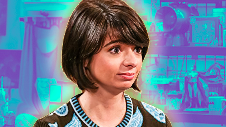 Lucy looking alarmed in front of a comic book store background on The Big Bang Theory