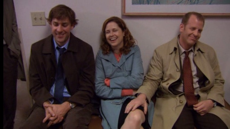 Jim and Pam and Toby laughing with Toby's hand on Pam's knee on The Office