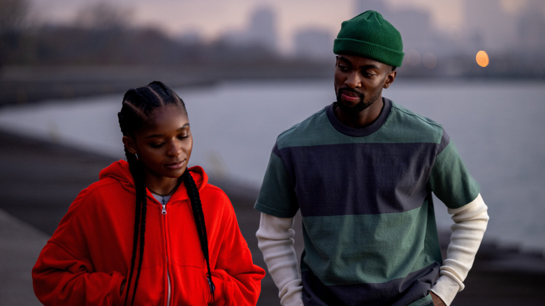 Riri and Xavier walk outside in "Ironheart" (2025)