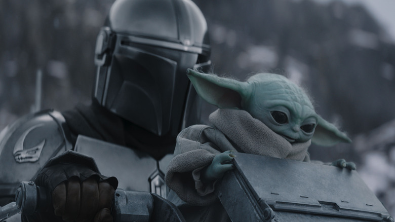 Din Djarin riding a space cruiser with Grogu in The Mandalorian and Grogu