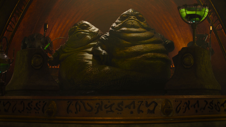 The Hutt twins sitting on a stage in The Mandalorian and Grogu
