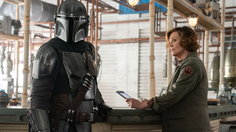 Ward looking at Din Djarin in The Mandalorian and Grogu