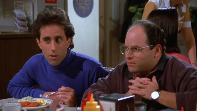 Jerry Seinfeld and George Constanza sitting at a Monk's Café table on "Seinfeld" (1989-1998)
