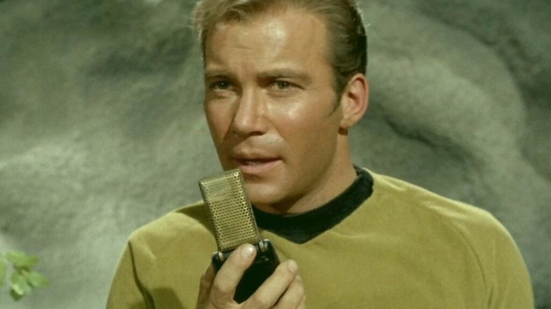 Captain Kirk using a communicator in "Star Trek"