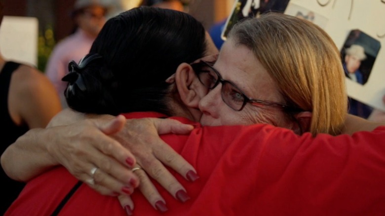Loved ones of victims hugging one another in Killing County