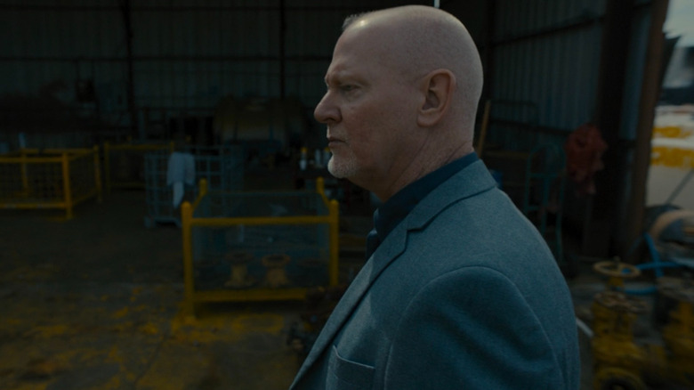 Gart Stewart looking around a warehouse in The Most Dangerous Animal of All