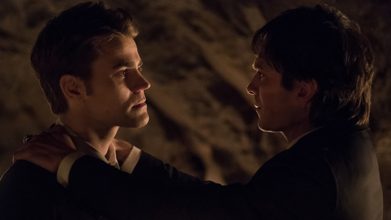 Stefan and Damon looking at each other dramatically in "The Vampire Diaries"