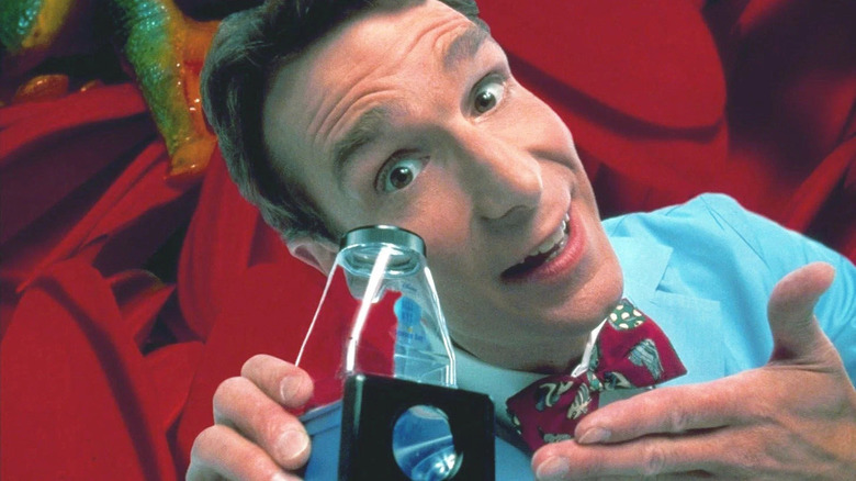 Bill Nye holding a scientific instrument by his face in "Bill Nye the Science Guy"