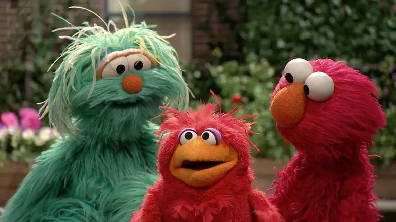 Rosita and Elmo looking at another puppet in "Sesame Street"
