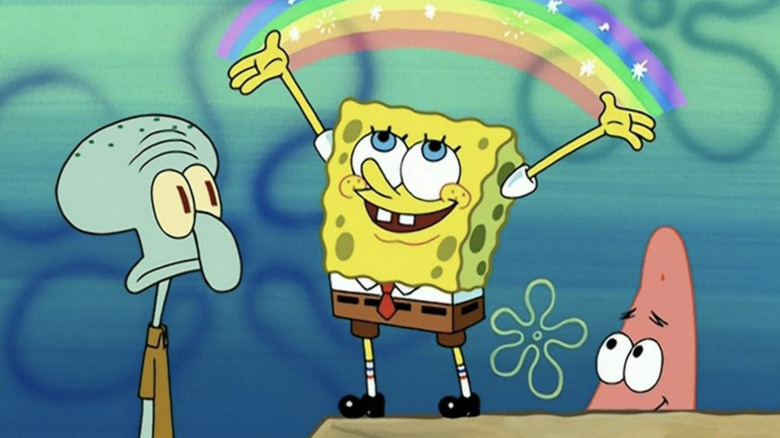 Squidward and Patrick looking at SpongeBob, who is making a rainbow with his hands, in "SpongeBob SquarePants"