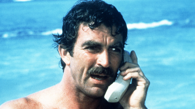 Magnum making a phone call in Magnum, P.I. (1980)
