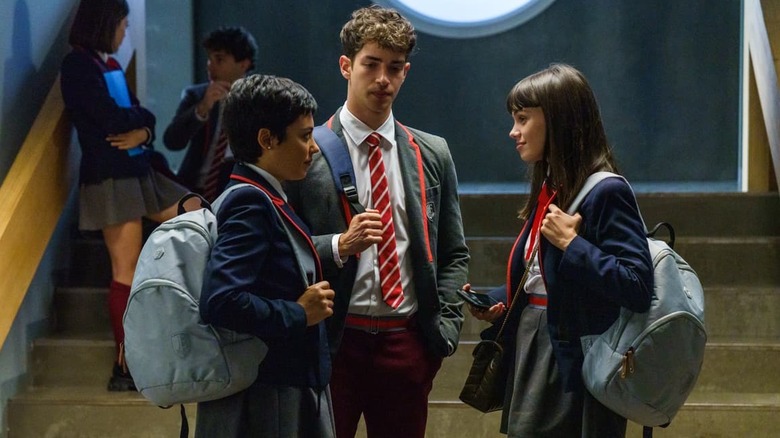 Students in uniform standing near stairs in Elité
