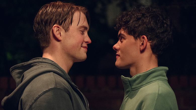Nick and Charlie smiling at each other in Heartstopper
