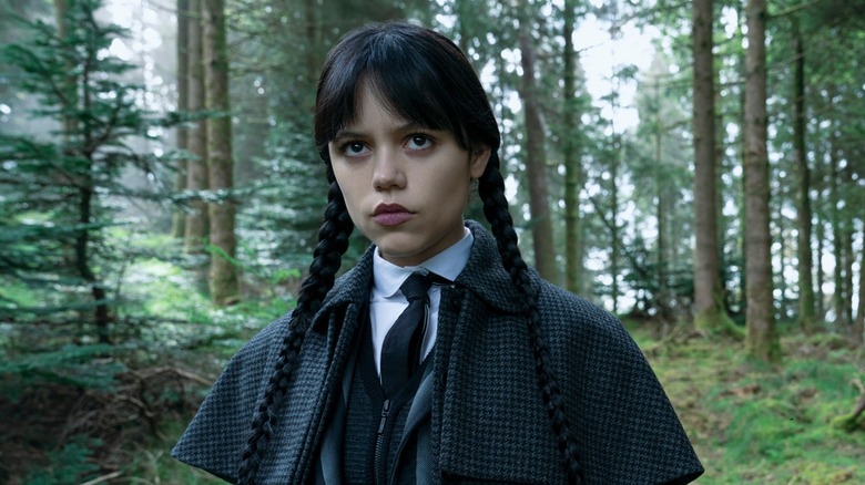 Wednesday Addams walking through the forest in Wednesday