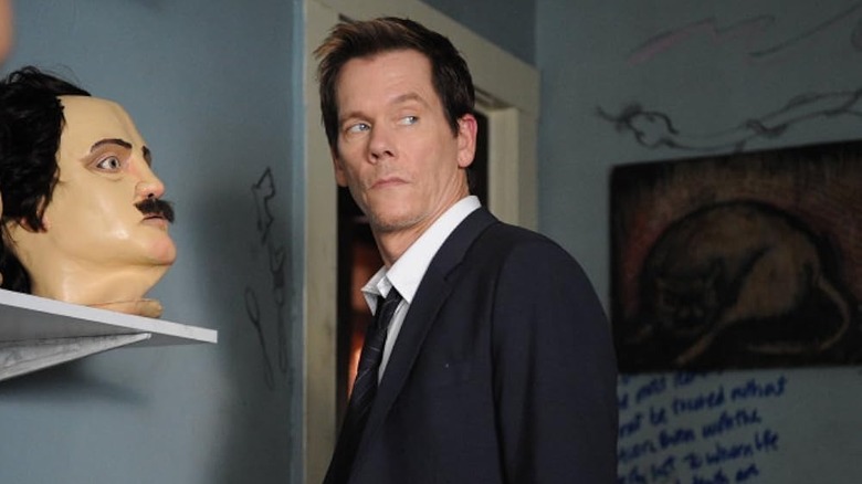 Ryan Hardy in a room with an Edgar Allan Poe mask in The Following