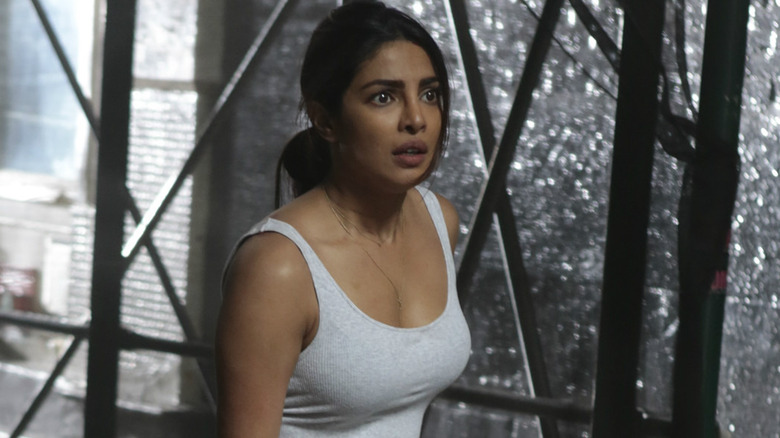 Alex in a tank top in front of a rain-soaked window in Quantico (2015)