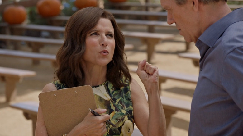 Selina Meyer holding a clipboard on Veep