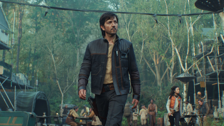 Cassian Andor walking through a forest society on Andor