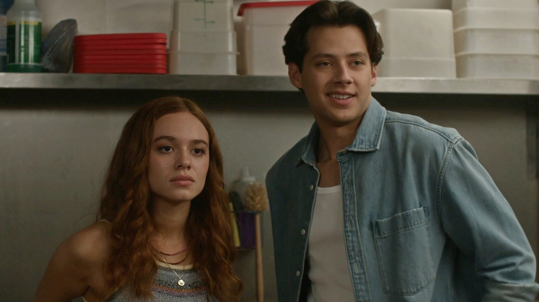 Percy stares blankly as Sam stands next to her shrugging in 