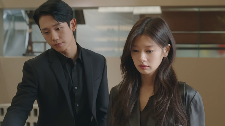 Seung-hyo and Seok-ryu looking down at something in "Love Next Door" (2024)