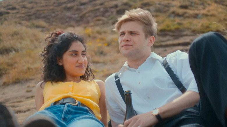 Emma looks at Dexter as they lie on the beach in "One Day" (2024)