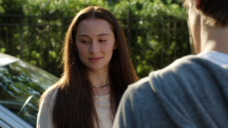 Belly looks shyly away from a boy halfway out of frame in "The Summer I Turned Pretty" (2022-2025)