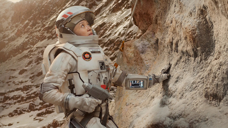 Astronaut in a suit on a rugged landscape in For All Mankind