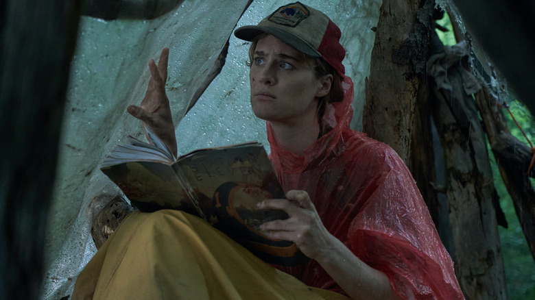 Kirsten reading a magazine in her tent in Station Eleven