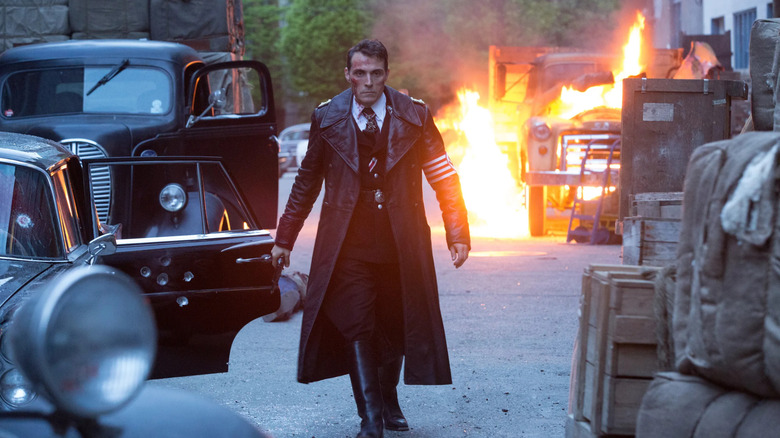 John Smith walking away from an explosion in The Man in the High Castle