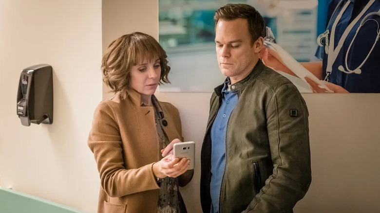 Sophie and Tom looking at a phone in Safe