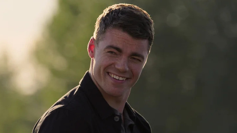 Peter Sutherland smiling on The Night Agent