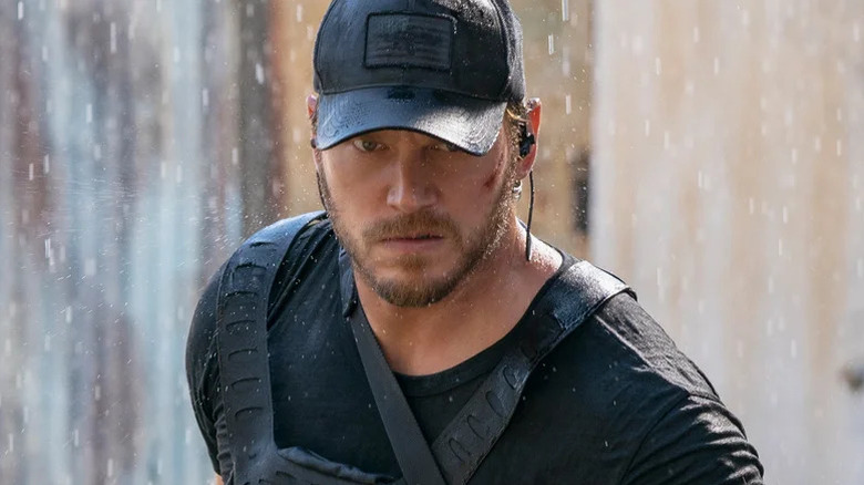 James Reece wearing black tactical gear and a baseball cap on The Terminal List