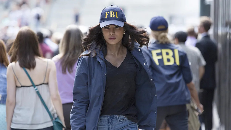 Alex walking down the street in FBI gear on Quantico