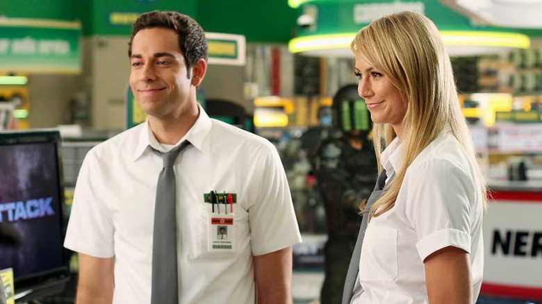 Chuck smiling next to a colleague at his day job in Chuck