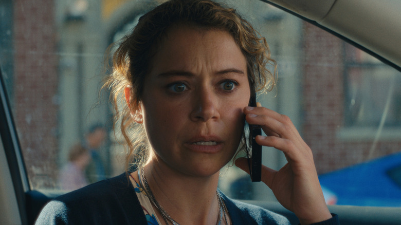Paula sitting in a car on a phone call in Maximum Pleasure Guaranteed