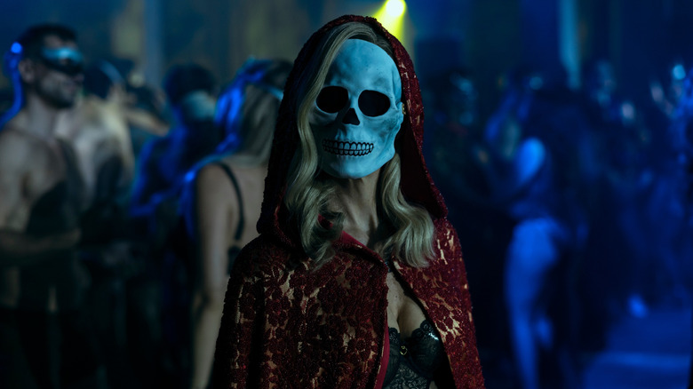 Woman wearing a skeletal mask at a party on The Fall of the House of Usher