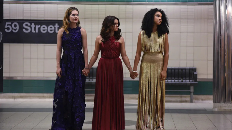 Sutton Jane and Kat holding hands in evening gowns in a subway station in The Bold Type
