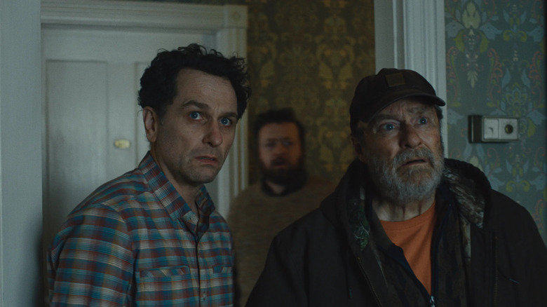 Tom and Wyck looking stunned in a hotel room on Widow's Bay