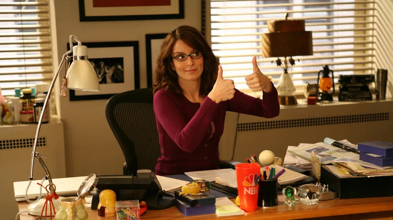 Liz giving two thumbs up at her desk on 30 Rock